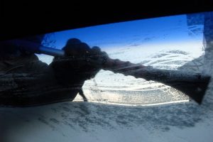 Scraping frost and ice off windscreen